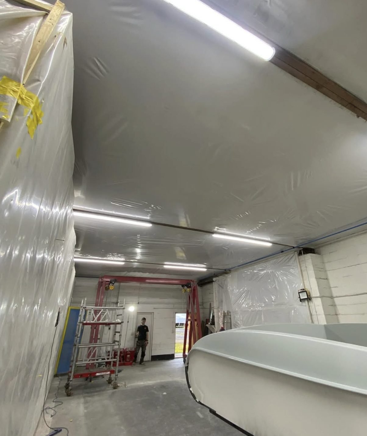 LED batten lighting fitted across the ceiling of a commercial workshop